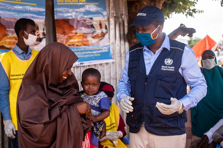 A young girl waits to be vaccinated