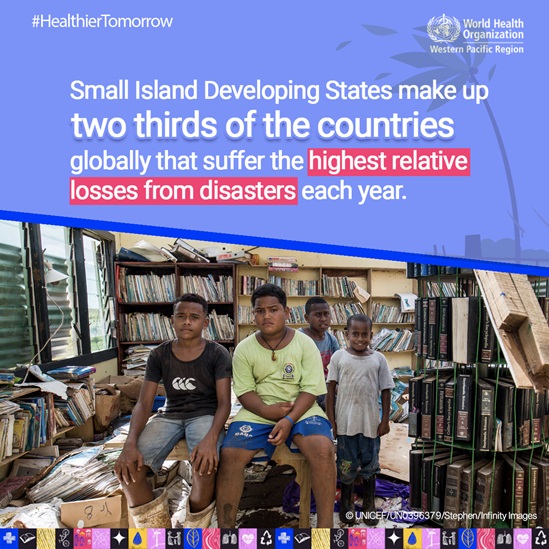Boys in Fiji examine their destroyed school after an extreme storm